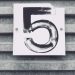 gray tile with white number five printed text